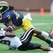 San Diego State defensive back Larry Parker takes down Michigan junior running back Vincent Smith during the football game at Michigan Stadium on Sept. 24, 2011. Angela J. Cesere | AnnArbor.com