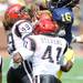 San Diego State defensive lineman J.J. Autele, left, and defensive back Khalid Stevens take down Michigan junior quarterback Denard Robinson during the football game at Michigan Stadium on Sept. 24, 2011. Angela J. Cesere | AnnArbor.com