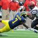 Michigan linebacker Brandin Hawthorne dives for San Diego State running back Ronnie Hillman during the football game at Michigan Stadium on Sept. 24, 2011. Angela J. Cesere | AnnArbor.com