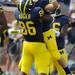 Michigan senior tight end Kevin Koger lifts sophomore wide reciever Drew Dileo after he scored a touchdown during the football game against Easten Michigan at Michigan Stadium on Saturday. Angela J. Cesere | AnnArbor.com