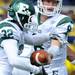 Eastern Michigan quarter back Alex Gillett passes the ball off to running back Javonti Greene during the football game against Michigan at Michigan Stadium on Saturday. Angela J. Cesere | AnnArbor.com
