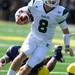 Eastern Michigan quarter back Alex Gillett escapes the grips of Michigan junior linebacker Kenny Demens during the football game at Michigan Stadium on Saturday. Angela J. Cesere | AnnArbor.com