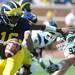 Michigan junior quarterback Denard Robinson escapes the grip of Eastern Michigan defensive lineman Brad Ohrman during the football game at Michigan Stadium on Saturday. Angela J. Cesere | AnnArbor.com