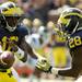 Michigan junior quarterback Denard Robinson pass the ball off to sophomore running back Fitzgerald Toussaint during the football game against Eastern Michigan at Michigan Stadium on Saturday. Angela J. Cesere | AnnArbor.com