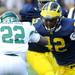 Michigan senior linebacker J.B. Fitzgerald, right, moves to block Eastern Michigan running back Ryan Brumfield the football game at Michigan Stadium on Saturday. Angela J. Cesere | AnnArbor.com