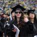 University of Michigan student Lindsay Acker gives a thumbs-up as she walks to the seating area before the class of 2012 commencement ceremony. Angela J. Cesere | AnnArbor.com