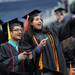 University of Michigan students Leen Khatib, right, and Firas Shalabi point into the crowd before the 2012 commencement ceremony at Michigan Stadium. Angela J. Cesere | AnnArbor.com