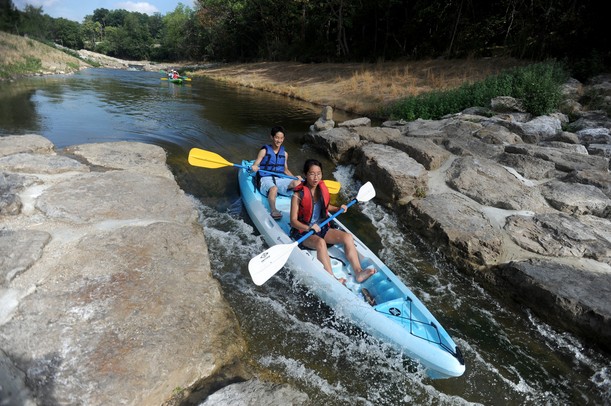 Ann Arbor residents Stephanie Huang, age 20, and her brother Daniel, age 18, take their kayak through the Argo Cascades in Ann Arbor on Saturday morning. Angela J. Cesere | AnnArbor.com 