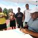 Harold Wimberly, right, who is a pastor at Christian Love Fellowship church located in the Washington Square neighborhood in Superior Township, writes down teams for the three-on-three Ballin' on the Boulevard basketball tournament held this past Wednesday evening at the tennis courts across from Cheney Academy in Superior Township. Angela J. Cesere | AnnArbor.com 
