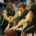 Huron's Antonio Henry, left, and Andre Bond, right, try to take the ball from Saline's Michael Hendrickson. Angela J. Cesere | AnnArbor.com