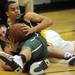 Saline's Joey Wooley tries to grab the ball from Huron's Mike Lewis after scrambling for a loose ball on the floor. Angela J. Cesere | AnnArbor.com