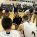 Saline basketball players huddle around head coach Matt Seidl during a time-out. Angela J. Cesere | AnnArbor.com