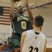 Huron's Antonio Henry jumps above Saline's Garrett Stark to take a shot. Angela J. Cesere | AnnArbor.com