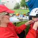  Ann Arbor Bicycle Touring Society member Christine Flaviani, left, helps fit a helmet on 2-year-old Ann Arbor resident Sumi Lama during the bike repair clinic at University Town Houses Co-op. Angela J. Cesere | AnnArbor.com