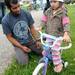 Volunteer Chris Ridgard, left, watches as 5-year-old Aliyah Carr tries out the adjusted seat on her bike. Angela J. Cesere | AnnArbor.com