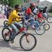 7-year-old Ann Arbor resident Bilal Kedir, left, tries to bike as slowly as possible without losing his balance during a slow biking race during the bike repair clinic at the University Town Houses Co-op. Angela J. Cesere | AnnArbor.com