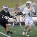 Pioneer's Erik Barroso, left, tries to knock the ball out of the hands of Holt's Erick Sundstrom during the MHSAA lacrosse semi-finals game at Parker Stadium in Howell, Mich. on Wednesday evening. Angela J. Cesere | AnnArbor.com