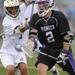 Holt's Drew Dyer, left, tries to knock the ball out of the net of Pioneer's Harry Hadden during the MHSAA lacrosse semi-finals game at Parker Stadium in Howell, Mich. on Wednesday evening. Angela J. Cesere | AnnArbor.com