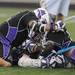 Pioneer teammates pile on Dylan Swanson after he scored the game winning double overtime goal at the MHSAA lacrosse semi-finals game against Holt at Parker Stadium in Howell, Mich. on Wednesday evening. Angela J. Cesere | AnnArbor.com