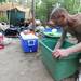 Camp Take Notice resident Tate Williams cleans out plastic tub for the move-out on Thursday afternoon. Angela J. Cesere | AnnArbor.com