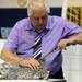 Gene Darrah, a judge with the Cat Fanciers' Association, checks out Hope, a silver Egyptian Mau cat from Washington D.C. at the Cat Fanciers' Association Cat Show. Angela J. Cesere | AnnArbor.com