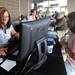 Roseville Costco manager Rolanda Kelley signs up Saline resident Jan Wurtzel for a Costco membership at the grand opening of the new Costco in Ann Arbor.  Angela J. Cesere | AnnArbor.com