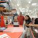 From left: Vitamix employee Rick Alana demonstrates how to make soup with the Vitamix for Saline residents Ted Ressler and Grace Wu, and Manchester resident Joyce Sroufe during the Costco grand opening in Ann Arbor on Friday morning. Angela J. Cesere | AnnArbor.com