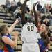 Lincoln Park's Ashley Majka, left, and Chanel Pearson, right, watch as Dexter's Sirah Camara jumps up for a shot. Angela J. Cesere | AnnArbor.com