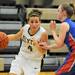 Dexter's Makenzie Svihra, left, dribbles past Lincoln Park's Paige Llanes. Angela J. Cesere | AnnArbor.com