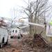 A worker from Altec, a utility company, strips a damaged utility pole to be removed from the side of Dexter-Pinckney road. Angela J. Cesere | AnnArbor.com
