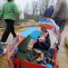 Pinckney residents Carmen Crawford, left, and her husband Rob, right, pull their children Jackson, age 3, center right, and Eli, age 2, center left, in a wagon during their Dexter Wellness Walk on Saturday morning. Angela J. Cesere | AnnArbor.com
