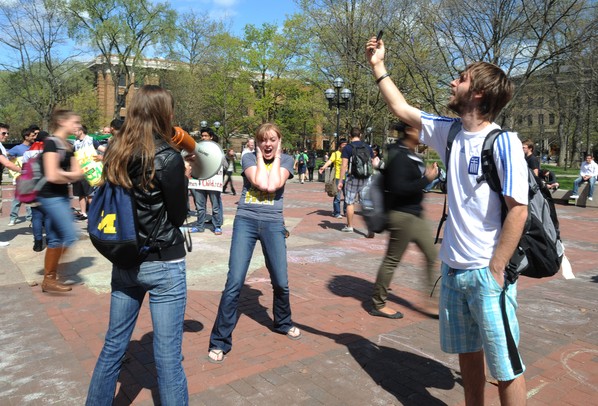 University of Michigan junior Keegan Cisowski, right, freezes in place with Do Random Acts of Kindness (DoRAK) co-director Rachael Crowe, center, and DoRAK special events chair Sarah Londal during an event on the University of Michigan Diag in Ann Arbor, Mich. on March 28, 2012.  The event called for participants to freeze in place for 5 minutes, starting at 2:33pm. Angela J. Cesere | AnnArbor.com