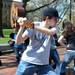 People walk by University of Michigan sophomore Scott Clancey, center, frozen in place while brandishing a guitar on the University of Michigan Diag in Ann Arbor, Mich. on March 28, 2012. Clancey, along with many others, participated in an event organized by the student group Do Random Acts of Kindness which called for participants to freeze in place for 5 minutes, starting at 2:33pm. Angela J. Cesere | AnnArbor.com