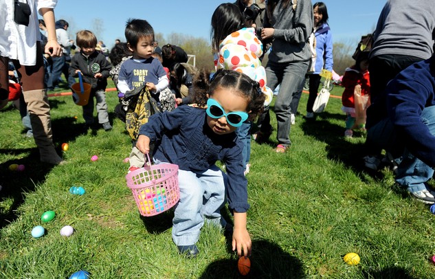 Ann Arbor resident Dalia Albashir, center, age 3, picks up a plastic egg during the egg scramble at Ann Arbor Jaycees Spring Eggstravaganza at Southeast Area Park in Pittsfield Township. Angela J. Cesere | AnnArbor.com