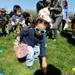 Ann Arbor resident Dalia Albashir, center, age 3, picks up a plastic egg during the egg scramble at Ann Arbor Jaycees Spring Eggstravaganza at Southeast Area Park in Pittsfield Township. Angela J. Cesere | AnnArbor.com
