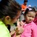 Ann Arbor resident Sherry Lin, age 3, has her face pained by Ann Arbor Teens for Kids volunteer Emma Kern during the Ann Arbor Jaycees Spring Eggstravaganza at Southeast Area Park in Pittsfield Township. Angela J. Cesere | AnnArbor.com