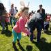 Dayton resident Kayli Doom, age 6, runs to pick up plastic eggs during the egg scramble at Ann Arbor Jaycees Spring Eggstravaganza at Southeast Area Park in Pittsfield Township. Angela J. Cesere | AnnArbor.com
