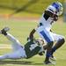 Eastern Michigan defensive back Marlon Pollard takes down Buffalo wide receiver Marcus Rivers. Angela J. Cesere | AnnArbor.com