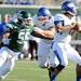Eastern Michigan defensive lineman Andy Mulumba, left, chases down Buffalo quarter back Chazz Anderson. Angela J. Cesere | AnnArbor.com