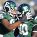 Eastern Michigan defensive end Kalonji Kashama, left, celebrates with defensive lineman Javon Reese after reese sacked Buffalo's quarter back. Angela J. Cesere | AnnArbor.com