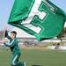 Eastern Michigan Spirit Squad member Ben Kinczkowski runs the 'E' flag down the end zone after a touchdown. Angela J. Cesere | AnnArbor.com