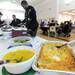 Baked macaroni and cheese, corn, and many other foods line the tables for the Fall Feast, held at Skyline High School. The feast is prepared in part by about 90 special education students from Skyline, Pioneer and Huron. AnnArbor.com | Angela J. Cesere