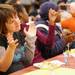 17-year-old Huron High School special education student Teadora Spremo, left, claps along with music during the Fall Feast.  AnnArbor.com | Angela J. Cesere
