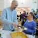 Pioneer High School teacher Terry Weaver, left,  helps 17-year-old Pioneer special education student Ariana Birdsong dish up baked macaroni and cheese. AnnArbor.com | Angela J. Cesere