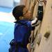 12-year-old Romulus resident Joe Bialek pulls himself up the wall at Planet Rock during the First Climb event. Angela J. Cesere | AnnArbor.com