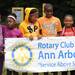 From left: Hikone residents Suzie Gibson, age 10, Angelica Johnson, age 10, Laquita Johnson, age 11, Antonia Brann, age 11, and B'nay Gardenhire, age 9, hold up a sign at the grand opening of their community's new fitness trail on Saturday morning, made possible through the help of the Rotary Club of Ann Arbor. Angela J. Cesere | AnnArbor.com 