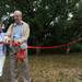 Community Action Network Executive Director Joan Doughty, left, cuts the ribbon for the new Hikone fitness trail with Rotary Club of Ann Arbor President Len Stenger.  Angela J. Cesere | AnnArbor.com 