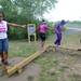 From left: Hikone residents Laquita Johnson, age 11, Angelica Johnson, age 10, Suzie Gibson, age 10, and B'nay Gardenhire, age 9, balance as they walk down a beam at a fitness station. Angela J. Cesere | AnnArbor.com 