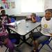 Hikone resident Laquita Johnson, age 11, right, smiles as she puts on her new t-shirt saying she completed the fitness trail.  Angela J. Cesere | AnnArbor.com 