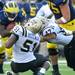 Western Michigan linebacker Desmond Bozeman, center, and linebacker Mitch Zajac, right, take down sophomore running back Fitzgerald Toussaint during the game at Michigan Stadium in Ann Arbor, Mich. on Sept. 3, 2011. Angela J. Cesere | AnnArbor.com